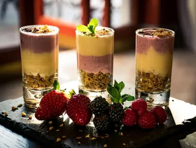 three cocktails with strawberries on a table at River Chateau Hotel in Rome