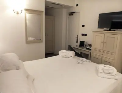 a hotel room with a bed with towels on it at BB Hotels Smarthotel Bailey's in Rome