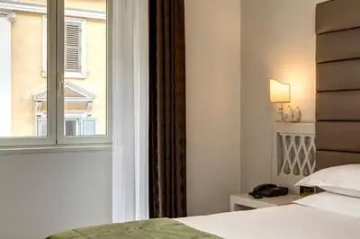 a bedroom with a bed and a window at BB Hotels Smarthotel Bailey's in Rome