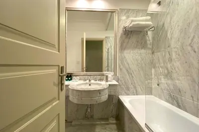 a bathroom with a sink and a tub and a mirror at BB Hotels Smarthotel Bailey's in Rome