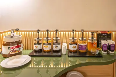 a counter with several bottles of honey on it at Gambrinus Hotel in Rome