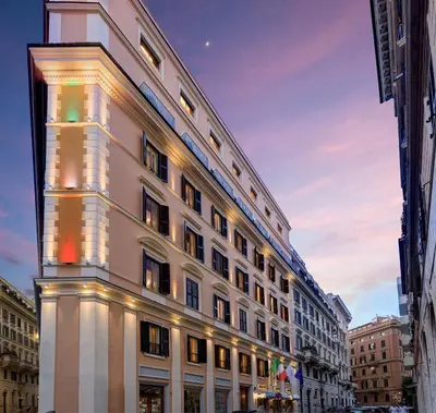 a white building with lights on the side of it at Marcella Royal Hotel - Rooftop Garden in Rome