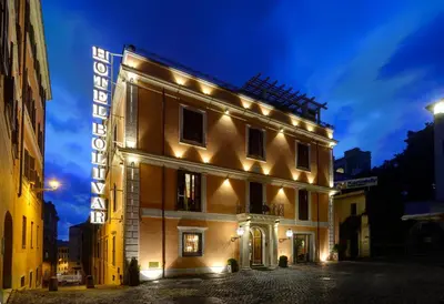 an entrance to a building with statues in a hallway at Hotel Bolivar in Rome
