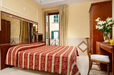 a hallway with a tile floor and a ceiling at Hotel Bolivar in Rome
