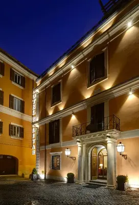 a large building with lights on it at night at Hotel Bolivar in Rome