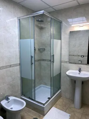 a bathroom with a glass shower and a sink at Hotel Alex Square in Rome