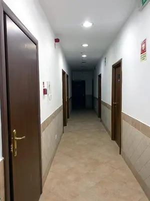 a hallway with doors and tile floors and a hallway with a hallway at Hotel Alex Square in Rome