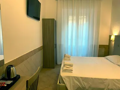 a hotel room with a bed and a window at Hotel Alex Square in Rome