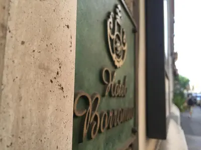 a sign on the side of a building at Hotel Borromeo in Rome