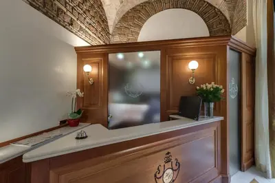 a reception desk with a mirror on top of it at Hotel Borromeo in Rome