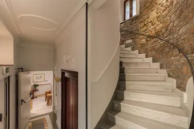 a staircase in a house with a brick wall at Hotel Borromeo in Rome