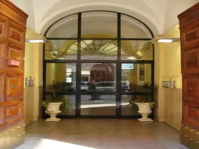 an entrance to a building with two vases in a hallway at Hotel Orlanda in Rome