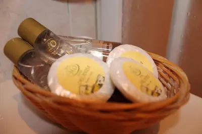 a basket with a bottle of wine and some candles at Hotel Orlanda in Rome