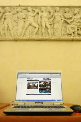 a laptop computer sitting on a desk in front of a wall at Hotel Orlanda in Rome