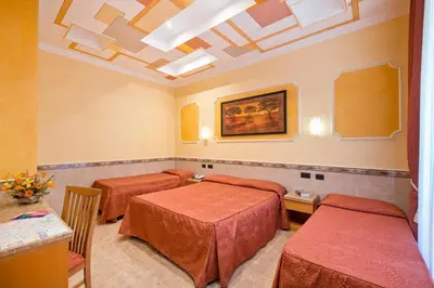 a hospital room with two beds and a table at Hotel Marco Polo Rome in Rome