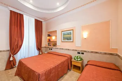 a hotel room with two beds and a window at Hotel Marco Polo Rome in Rome