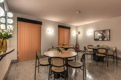 a group of tables and chairs in a room at Madison Hotel in Rome