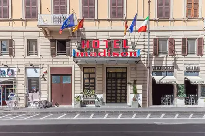 a hotel building with a hotel madrid sign and flags at Madison Hotel in Rome