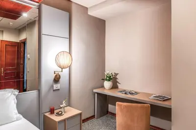 a bedroom with a desk and a bed and a desk at Madison Hotel in Rome
