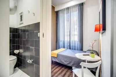 a small room with a bed and a bathroom at Hotel Seiler in Rome