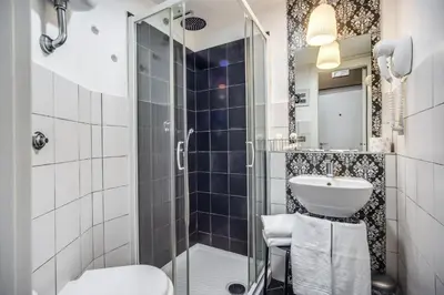 a bathroom with a shower and a toilet and a sink at Hotel Seiler in Rome