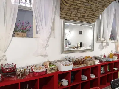 a red shelf with food on it with a mirror at Hotel Seiler in Rome
