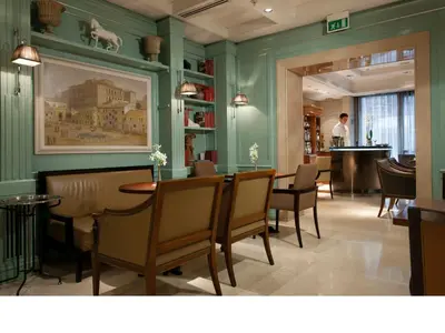 a restaurant with green walls and a table and chairs at Stendhal Hotel in Rome