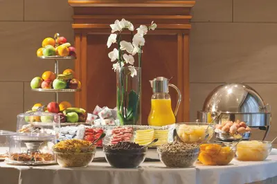 a table with a buffet of food and fruit at Stendhal Hotel in Rome
