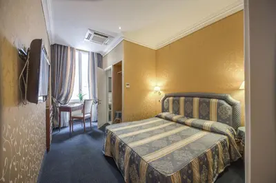 a hotel room with a bed and a desk at 939 Hotel in Rome