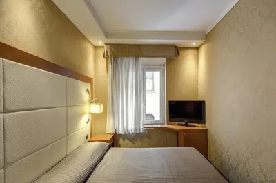 a hotel room with a bed and a television at 939 Hotel in Rome