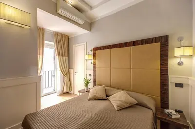 a bedroom with a large bed with a large headboard at 939 Hotel in Rome
