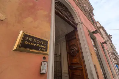 a sign on the side of a building next to a door at 939 Hotel in Rome