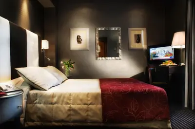 a hotel room with a bed and a mirror at Hotel Morgana in Rome