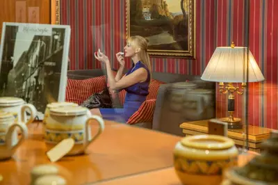 a woman sitting in a chair in a room with a mirror at Hotel Morgana in Rome