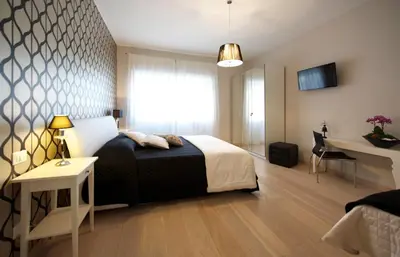a bedroom with a bed and a table and a desk at Quartopiano Guesthouse in Rome