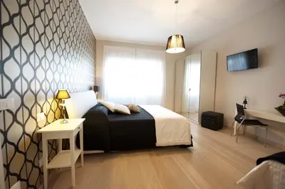 a bedroom with a bed and a table and a desk at Quartopiano Guesthouse in Rome