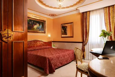 a restaurant with a bar with brown leather chairs and a table at Hotel Principessa Isabella in Rome