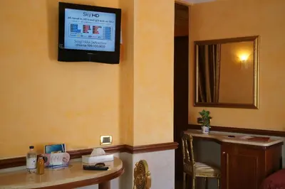 a hotel room with a television on the wall at Hotel Principessa Isabella in Rome