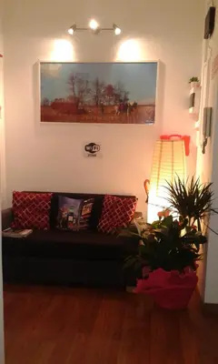 a living room with a couch and a plant at Vesta Domus in Rome