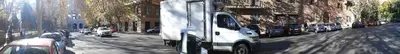 a white van is driving down a city street at Vesta Domus in Rome