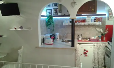 a small kitchen with a sink and a counter at Vesta Domus in Rome