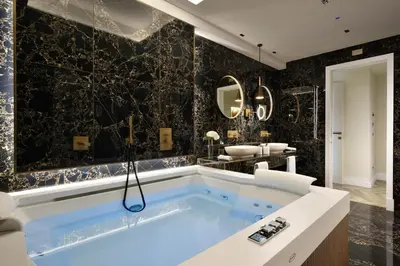 a bathroom with a tub and a sink at FH55 Grand Hotel Palatino in Rome