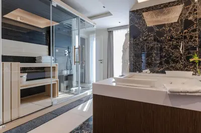 a bathroom with a sink and a mirror at FH55 Grand Hotel Palatino in Rome