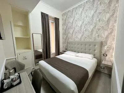 a hotel room with a bed and a mirror at Hotel Le Petit in Rome