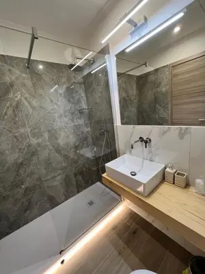 a bathroom with a sink and a shower at Hotel Le Petit in Rome