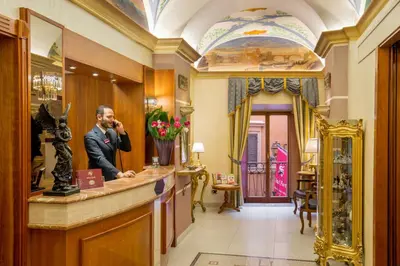 a man talking on a cell phone at a bar at Hotel Forte in Rome