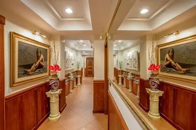 a hallway with paintings on the walls and vases at Hotel Forte in Rome