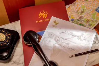 a guest book and a card on a table at Hotel Forte in Rome