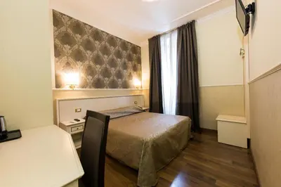a hotel room with a bed and a window at Hotel Anfiteatro Flavio in Rome