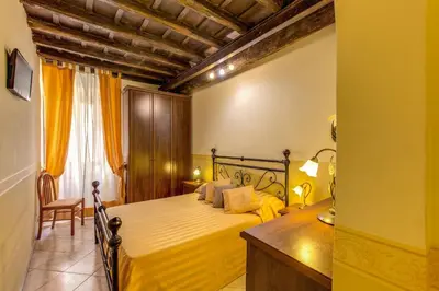 a bedroom with a bed and a desk at Hotel Anfiteatro Flavio in Rome